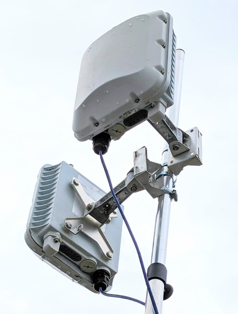 Weatherproof wireless access point mounted on an outdoor mast