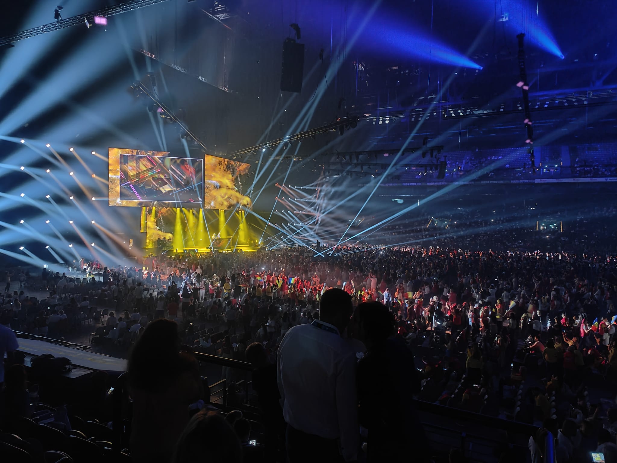 Audience beneath blue stage lighting