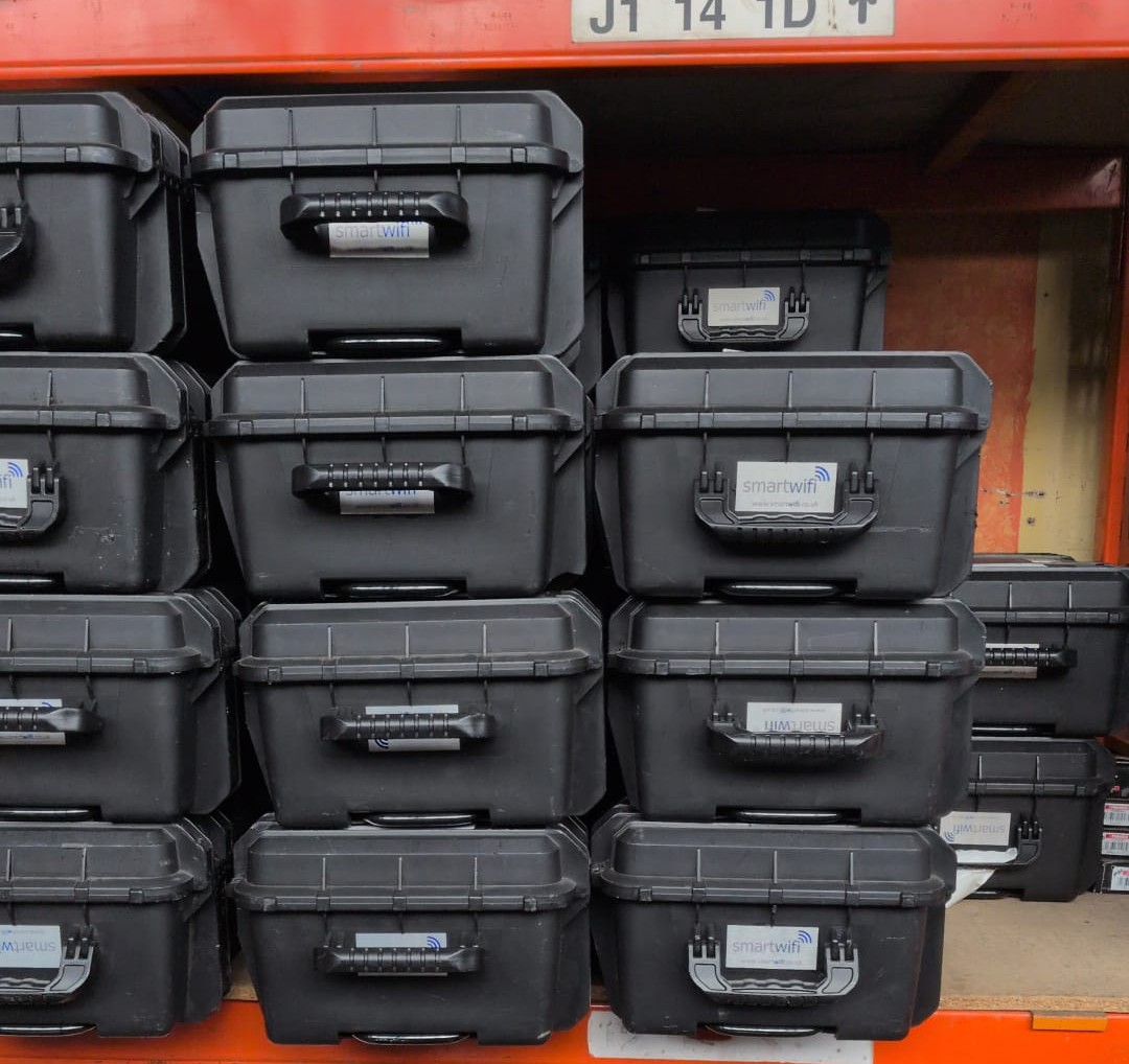 Portable connectivity kit cases stored in a warehouse